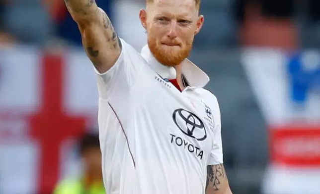 England's captain Ben Stokes raises the ball after taking five wickets during the first Ashes cricket test match between Australia and England in Perth, Friday, Nov. 21, 2025.(AP Photo/Gary Day)