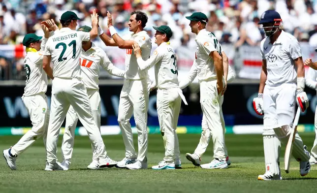 Australia's Mitchell Starc, center, celebrates with teammates the wicket of England's Gus Atkinson during the first Ashes cricket test match between Australia and England in Perth, Friday, Nov. 21, 2025.(AP Photo/Gary Day)