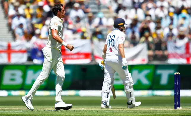 Australia's Mitchell Starc celebrates the wicket of England's Joe Root, right, during the first Ashes cricket test match between Australia and England in Perth, Friday, Nov. 21, 2025.(AP Photo/Gary Day)
