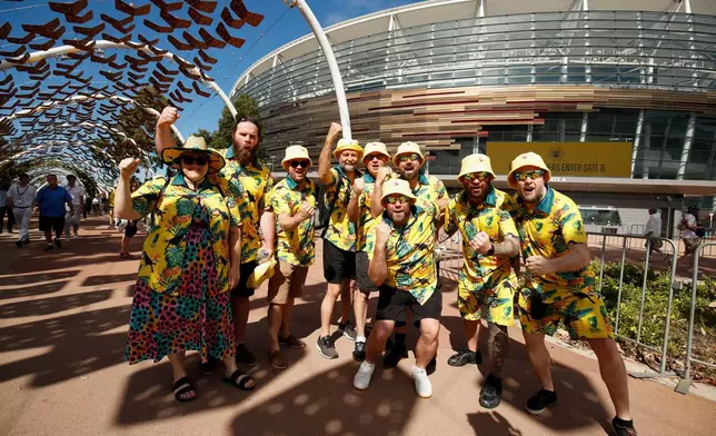 Australia's fans react to the camera as they arrive to watch the first Ashes cricket test match between Australia and England in Perth, Friday, Nov. 21, 2025.(AP Photo/Gary Day)