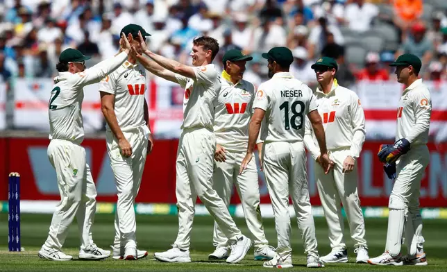 Australia's Brendan Doggett, third left, celebrates with teammates the wicket of England's Harry Brook during the first Ashes cricket test match between Australia and England in Perth, Friday, Nov. 21, 2025.(AP Photo/Gary Day)