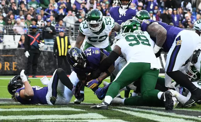 Baltimore Ravens running back Derrick Henry (22) scores a touchdown during the second half of an NFL football game against the New York Jets, Sunday, Nov. 23, 2025, in Baltimore. (AP Photo/Nick Wass)