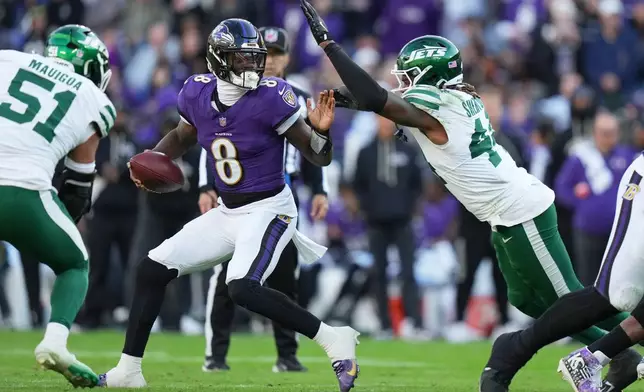 New York Jets linebacker Jamien Sherwood (44) defends Baltimore Ravens quarterback Lamar Jackson (8) during the second half of an NFL football game, Sunday, Nov. 23, 2025, in Baltimore. (AP Photo/Stephanie Scarbrough)