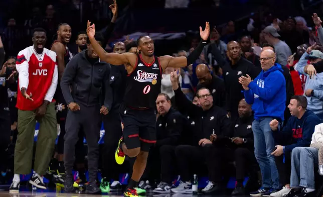 Philadelphia 76ers' Tyrese Maxey (0) reacts after the second of his back-to-back 3-point baskets during the first half of an NBA basketball game against the Miami Heat, Sunday, Nov. 23, 2025, in Philadelphia. (AP Photo/Chris Szagola)