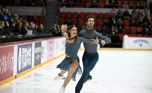 Laurence Fournier Beaudry and Guillaume Cizeron, of France, perform in the free dance program of the ice dancing competition at the ISU Grand Prix figure skating event in Helsinki, Finland, Saturday Nov. 22, 2025. (Mikko Stig/Lehtikuva via AP)