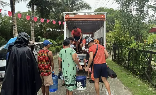 In this photo, provided by the Philippine Coast Guard, residents are evacuated to safer grounds as Typhoon Kalmaegi nears the area of Guiuan, Eastern Samar province, central Philippines on Monday Nov. 3, 2025. (Philippine Coast Guard via AP)