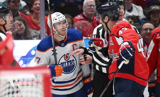 Edmonton Oilers center Connor McDavid (97) and Washington Capitals right wing Tom Wilson (43) exchange words during the second period of an NHL hockey game, Wednesday, Nov. 19, 2025, in Washington. (AP Photo/Nick Wass)
