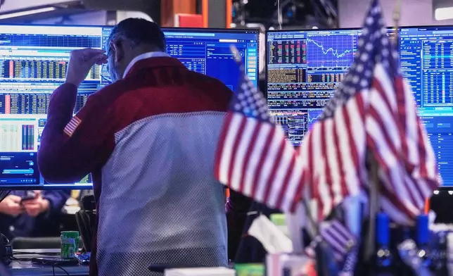 Trader Anan Patel works on the floor of the New York Stock Exchange, Tuesday, Nov. 18, 2025. (AP Photo/Richard Drew)