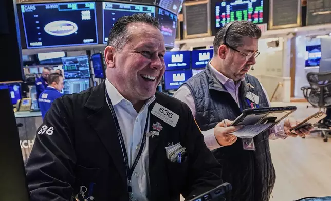 Traders Edward Curran, left, and Michael Capolino work on the floor of the New York Stock Exchange, Thursday, Nov. 20, 2025. (AP Photo/Richard Drew)