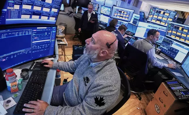Trader Vincent Napolitono, foreground, works on the floor of the New York Stock Exchange, Thursday, Nov. 20, 2025. (AP Photo/Richard Drew)
