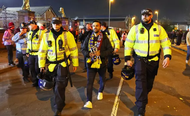 Maccabi Tel Aviv's fan is escorted by police ahead of the Europa League soccer match between Aston Villa and Maccabi Tel Aviv in Birmingham, England, Thursday, Nov. 6, 2025. (AP Photo/Darren Staples)