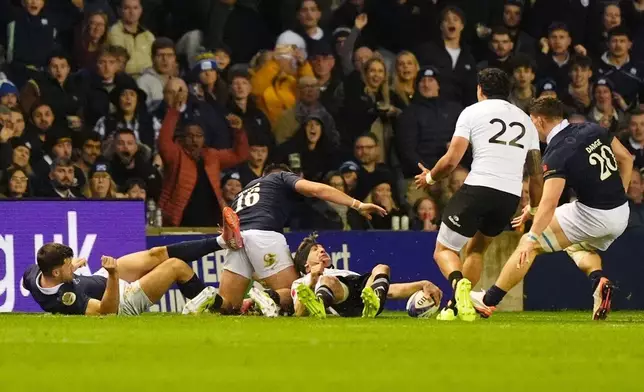 New Zealand's Damian McKenzie scores their side's third try during the Quilter Nations Series rugby match between Scotland and New Zealand in Edinburgh, Scotland, Saturday, Nov. 8, 2025. (Andrew Milligan/PA via AP)