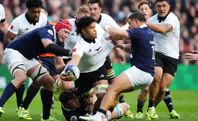New Zealand's Wallace Sititi is tackled by Scotland's Sione Tuipulotu during Rugby Union Autumn Series match between Scotland and New Zealand in Edinburgh, Scotland, Saturday, Nov. 8, 2025. (Andrew Milligan/PA via AP)