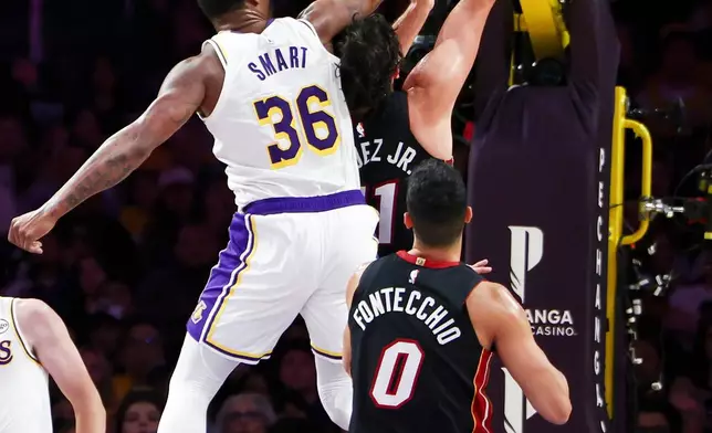 Los Angeles Lakers guard Marcus Smart (36) defends against Miami Heat forward Jaime Jaquez Jr., right, as Miami Heat forward Simone Fontecchio (0) watches during the first half of an NBA basketball game, Sunday, Nov. 2, 2025, in Los Angeles. (AP Photo/Jessie Alcheh)