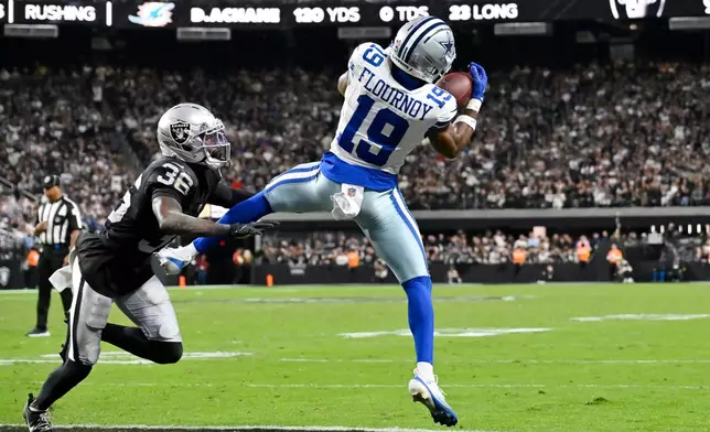 Dallas Cowboys wide receiver Ryan Flournoy (19) makes a touchdown catch against Las Vegas Raiders cornerback Kyu Blu Kelly (36) during the second half of an NFL football game Monday, Nov. 17, 2025, in Las Vegas. (AP Photo/David Becker)