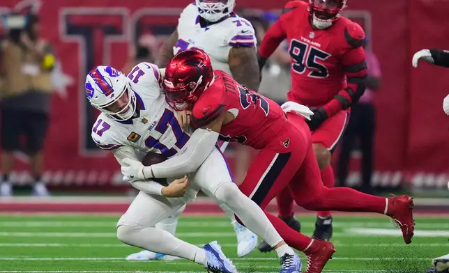 Buffalo Bills quarterback Josh Allen (17) is sacked by Houston Texans linebacker Henry To'oTo'o (39) in the second half of an NFL football game Thursday, Nov. 20, 2025, in Houston. (AP Photo/Ashley Landis)