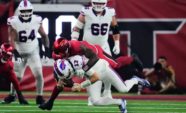 Buffalo Bills quarterback Josh Allen (17) is sacked by Houston Texans defensive end Will Anderson Jr. (51) in the first half of an NFL football game Thursday, Nov. 20, 2025, in Houston. (AP Photo/Ashley Landis)