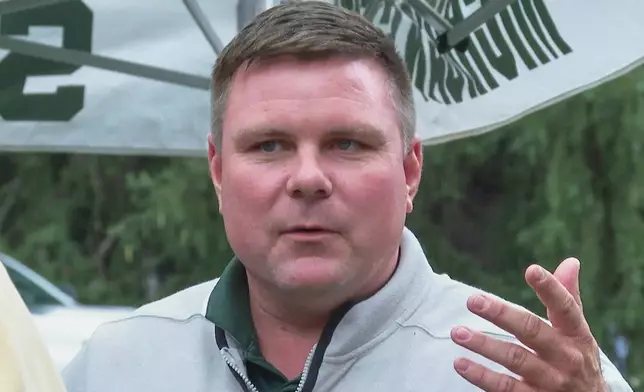 In this image made from video former Sparty mascot, Scott Ferry, talks to friends during a pregame tailgate on Michigan State University campus, Sept. 6, 2025, in East Lansing, Mich. (AP Photo/Mike Householder)