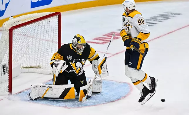 Penguins goalie Sergei Murashov and Predators Ryan O'Reilly in action during the NHL Global Series hockey game between the Pittsburgh Penguins and the Nashville Predators in Stockholm, Sweden, Sunday, Nov. 16, 2025. (Claudio Bresciani/TT News Agency via AP)
