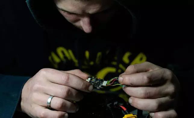 A Khartia brigade soldier assembles a drone, Friday, Nov. 7, 2025, in Kharkiv Oblast, Ukraine. (AP Photo/Julia Demaree Nikhinson)