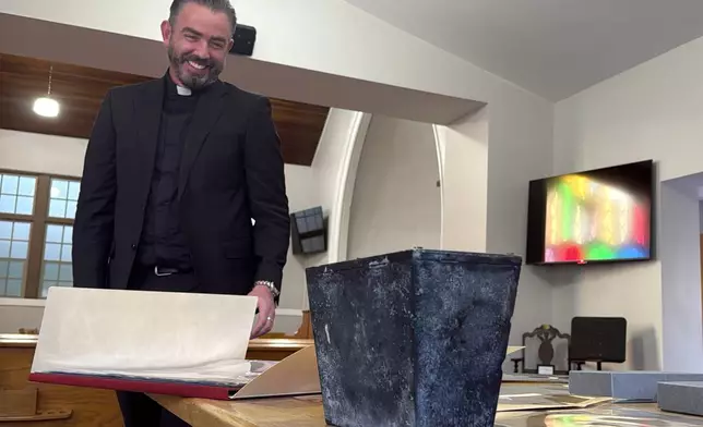 Rev. Andrew Fleishman looks at a century-old time capsule at the Japanese Church of Christ in Salt Lake City, Monday, Nov. 3, 2025. (AP Photo/Hannah Schoenbaum)
