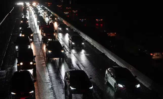 Cars drive on the Baltimore/Washington Parkway as seen from an overpass in Halethorpe, Md., Tuesday, Nov. 25, 2025. (AP Photo/Stephanie Scarbrough)