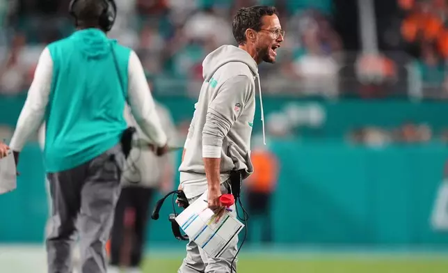 Miami Dolphins head coach Mike McDaniel reacts during the first half of an NFL football game against the Baltimore Ravens, Thursday, Oct. 30, 2025, in Miami Gardens, Fla. (AP Photo/Rebecca Blackwell)