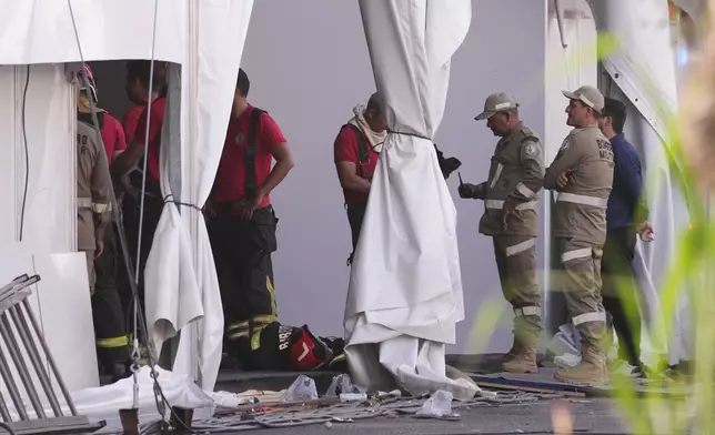 Firefighters and emergency personnel work at the scene after a fire at the COP30 U.N. Climate Summit, Thursday, Nov. 20, 2025, in Belem, Brazil. (AP Photo/Andre Penner)