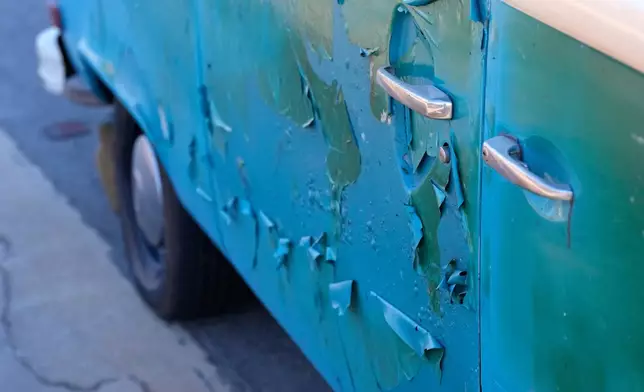 FILE - The Volkswagen bus, named Azul by its owner, sits with some damage in front of burned out homes, Wednesday, Jan. 15, 2025, in Malibu, Calif. (AP Photo/Mark J. Terrill, File)