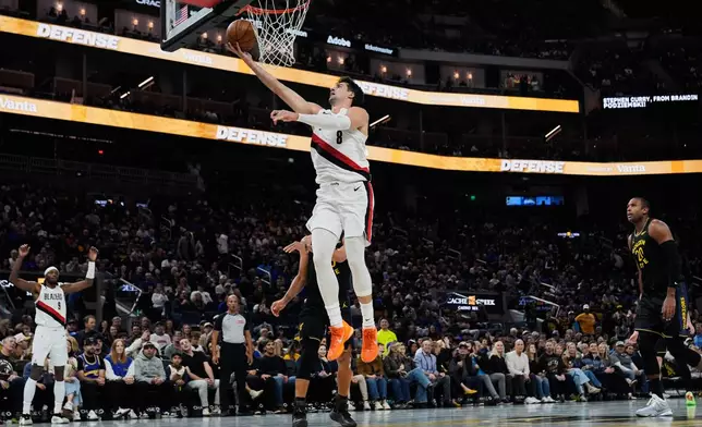Portland Trail Blazers forward Deni Avdija (8) shoots next to Golden State Warriors guard Stephen Curry (30) during the first half of an NBA Cup basketball game, Friday, Nov. 21, 2025, in San Francisco. (AP Photo/Godofredo A. Vásquez)