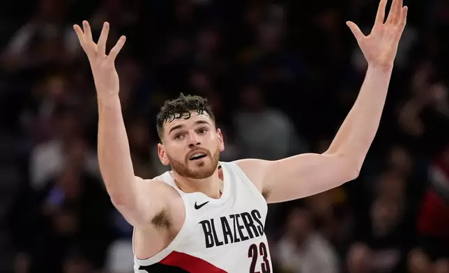Portland Trail Blazers center Donovan Clingan reacts after making a 3-point basket during the second half of an NBA Cup basketball game against the Golden State Warriors, Friday, Nov. 21, 2025, in San Francisco. (AP Photo/Godofredo A. Vásquez)