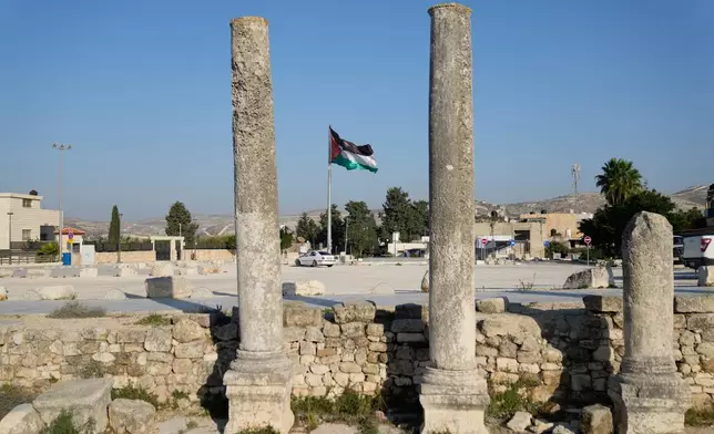 A Palestinian flag flies over the Roman historical site in the West Bank town of Sebastia Thursday, Nov. 20, 2025. (AP Photo/Nasser Nasser)