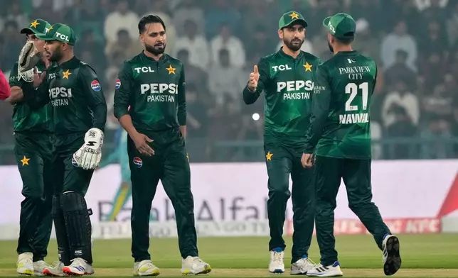 Pakistan's Faheem Ashraf, center, celebrates with teammates after the dismissal of South Africa's Ottneil Baartman during the second T20 cricket match between Pakistan and South Africa, in Lahore, Pakistan, Friday, Oct. 31, 2025. (AP Photo/K.M. Chaudary)