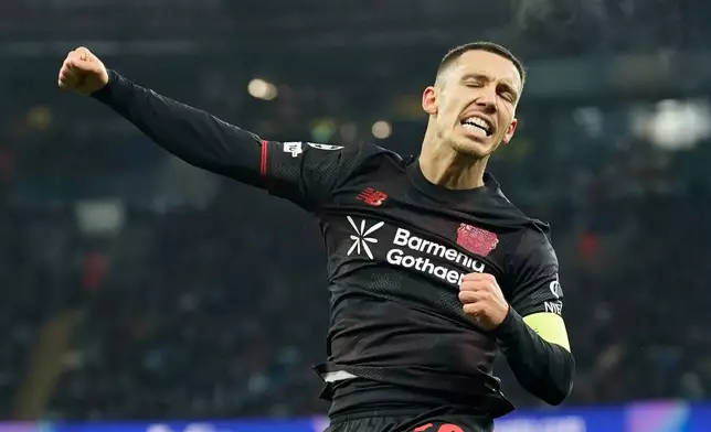 Leverkusen's Alex Grimaldo celebrates after scoring the opening goal of the game during the Champions League opening phase soccer match between Manchester City and Bayer Leverkusen in Manchester, England, Tuesday, Nov. 25, 2025. (AP Photo/Dave Thompson)