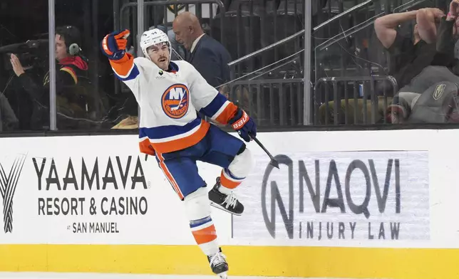New York Islanders center Jean-Gabriel Pageau (44) celebrates his goal against the Vegas Golden Knights in overtime of an NHL hockey game Thursday, Nov. 13, 2025, in Las Vegas. (AP Photo/Candice Ward)