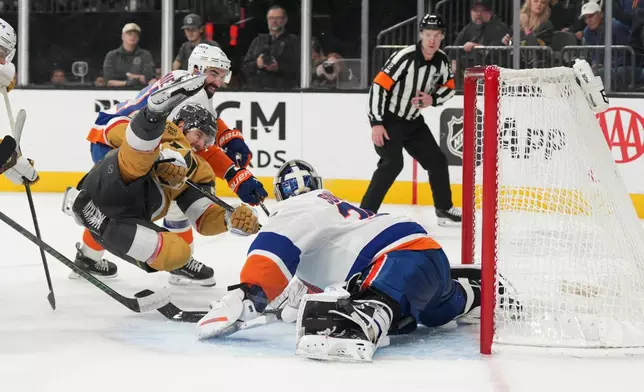 Vegas Golden Knights defenseman Shea Theodore (27) scores against New York Islanders goaltender Ilya Sorokin (30) in the second period of an NHL hockey game Thursday, Nov. 13, 2025, in Las Vegas. (AP Photo/Candice Ward)