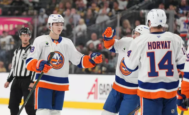 New York Islanders defenseman Matthew Schaefer (48) celebrates after his first-period goal against the Vegas Golden Knights in an NHL hockey game Thursday, Nov. 13, 2025, in Las Vegas. (AP Photo/Candice Ward)