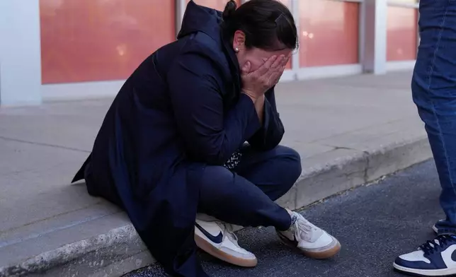 Maria Guzman, a parent of young children, is emotional after speaking outside of Rayito de Sol Spanish Immersion Early Learning Center after an employee of the preschool was arrested by federal immigration agents, Wednesday, Nov. 5, 2025, in Chicago. (AP Photo/Erin Hooley)