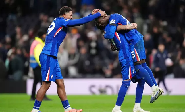 Chelsea's Moises Caicedo, right, Wesley Fofana, left, and Malo Gusto celebrate after the English Premier League soccer match between Tottenham Hotspur and Chelsea in London, Saturday, Nov. 1, 2025. (John Walton/PA via AP)