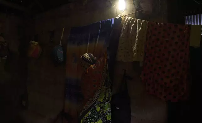 A "Solar Mama" technician wires up a solar charge controller at the campus of Barefoot College International in Kinyasini, Unguja, Zanzibar, July 23, 2025. (AP Photo/Jack Denton)
