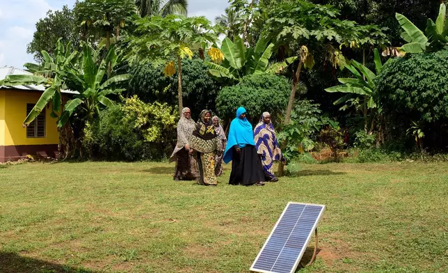 "Solar Mama" technicians walk on the campus of Barefoot College International in Kinyasini, Unguja, Zanzibar, July 23, 2025. (AP Photo/Jack Denton)