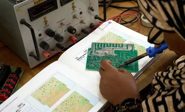 A "Solar Mama" technician takes a training session on the campus of Barefoot College International in Kinyasini, Unguja, Zanzibar, July 23, 2025. (AP Photo/Jack Denton)