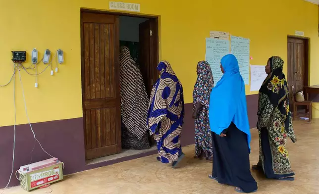"Solar Mama" technicians walk into a classroom on the campus of Barefoot College International in Kinyasini, Unguja, Zanzibar, July 23, 2025. (AP Photo/Jack Denton)