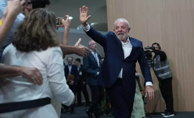Brazil President Luiz Inacio Lula da Silva waves as he arrives for a news conference at the COP30 U.N. Climate Summit, Wednesday, Nov. 19, 2025, in Belem, Brazil. (AP Photo/Andre Penner)