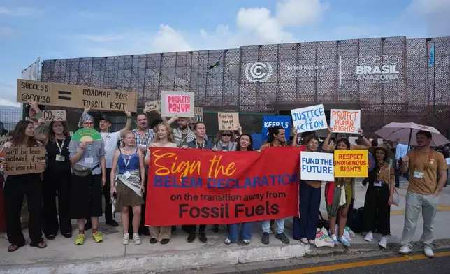 Activists participate in a demonstration to transition away from fossil fuels outside the venue for the COP30 U.N. Climate Summit, Wednesday, Nov. 19, 2025, in Belem, Brazil. (AP Photo/Andre Penner)