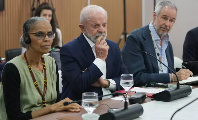Brazil President Luiz Inacio Lula da Silva, center, sits with Marina Silva, Brazil environment minister, left, and André Corrêa do Lago, COP30 president, during a meeting with leaders from from Jamaica, Palau, Maldives at the COP30 U.N. Climate Summit, Wednesday, Nov. 19, 2025, in Belem, Brazil. (AP Photo/Andre Penner)