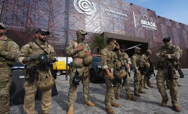Security personnel work outside an entrance to the COP30 U.N. Climate Summit, Wednesday, Nov. 19, 2025, in Belem, Brazil. (AP Photo/Andre Penner)
