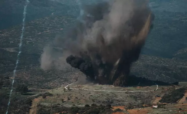 A huge explosion erupts during a live-fire exercise near the northeastern city of Alexandroupolis, Greece testing domestically-developed drones and counter-drone systems as part of NATO's modernization efforts on Friday, Nov. 14, 2025. (AP Photo/Thanassis Stavrakis)