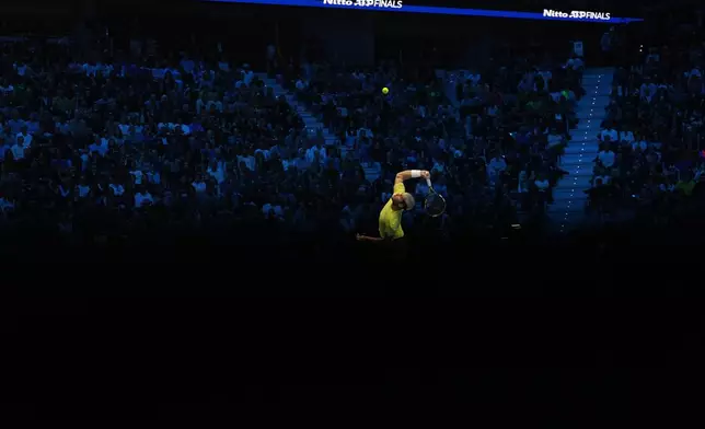 Spain's Carlos Alcaraz serves to Canada's Felix Auger-Aliassime during semifinal tennis match of the ATP World Tour Finals, in Turin, Italy, Saturday, Nov. 15, 2025. (AP Photo/Antonio Calanni)