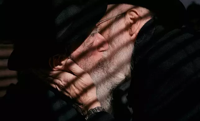 Chabad-Lubavitch rabbis kiss as they gather at the resting place of the Rebbe, Rabbi Menachem M. Schneerson, one of Judaism’s most influential figures, in the Queens borough of New York on Friday, Nov. 14, 2025, during the International Conference of Chabad-Lubavitch Emissaries. (AP Photo/Andres Kudacki)